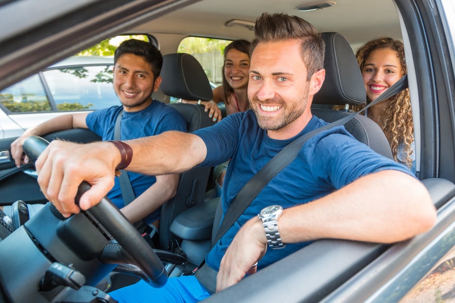 Happy smiling people sharing car ride